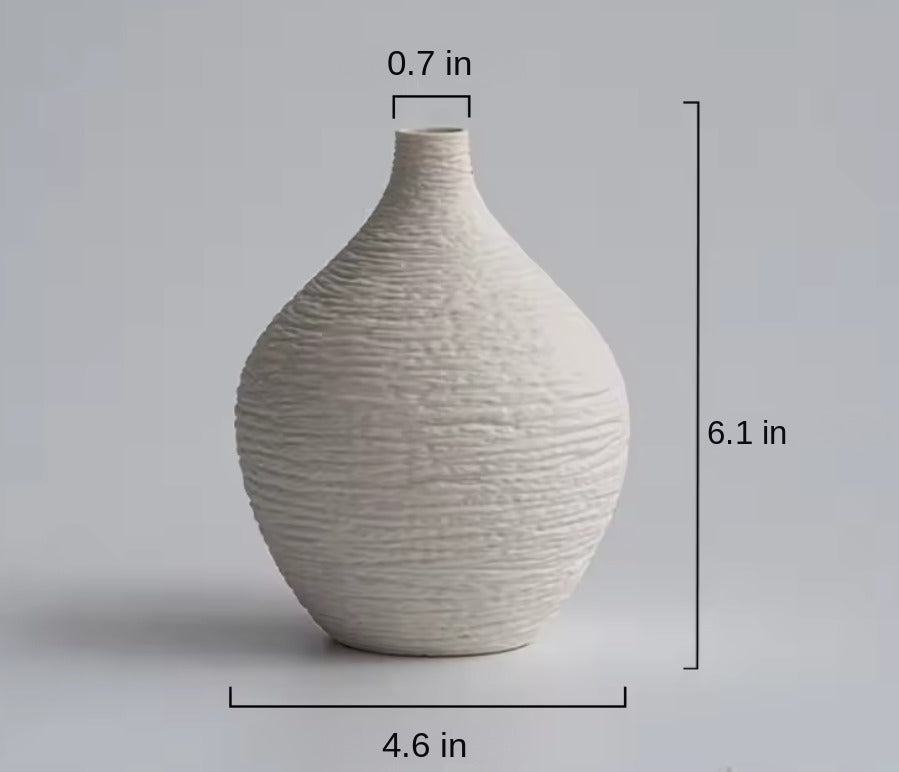 Small beige textured ceramic bud vase with size labels in inches