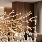 Close-up of gold coral-branch arms hung with K9 crystal drops