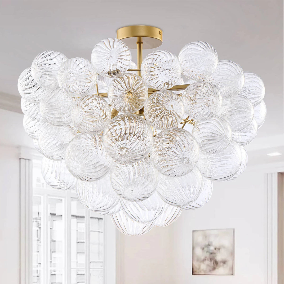 Close-up of the ribbed glass globe cluster semi-flush chandelier on a brass canopy