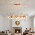Gold coral branch crystal chandelier above a fireplace in a white living room
