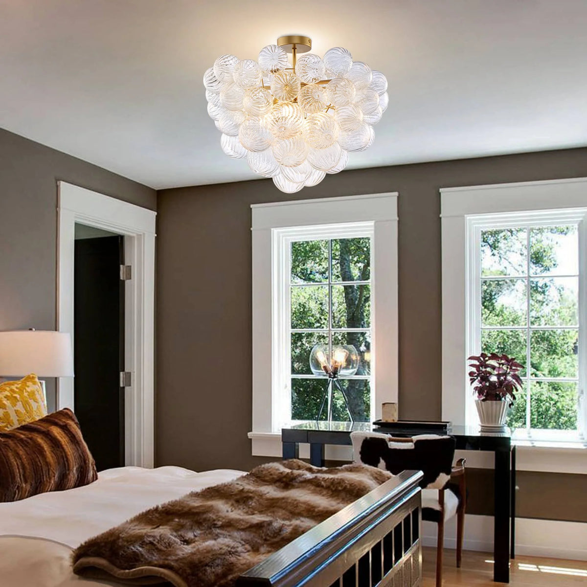 Ribbed glass globe cluster chandelier mounted semi-flush above a bedroom with tall windows