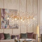Gold coral branch crystal chandelier, 49.2 in, lit above a living room sofa
