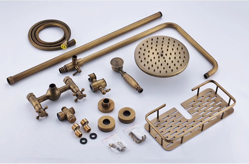 Unassembled antique brass exposed shower set with riser pipe, shower head, handshower and shelf