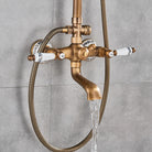 Antique brass exposed shower mixer with porcelain handles filling water against gray tile