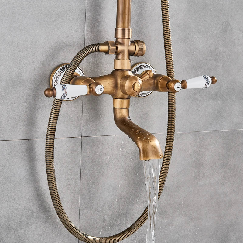 Antique brass exposed shower mixer with porcelain handles filling water against gray tile