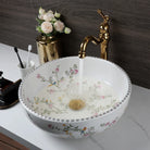 Flower-and-bird porcelain sink with gold faucet, front view