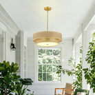 Rattan and linen chandelier with gold-tone rod in a bright white room
