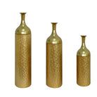Three gold metal floor vases, studio view