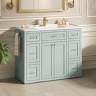 Mint green bathroom vanity with brass faucet in a traditional bath