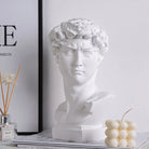 White classical David bust with a gold eye band, styled on a shelf