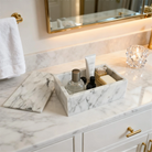 Carrara marble vanity box holding toiletries on a bathroom counter