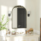 Antique silver baroque arched mirror in a white bathroom