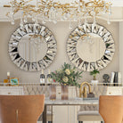 Pair of round sunburst mirrors hung above a dining banquette