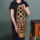 Model holding the 24-inch gold openwork vase to show its size