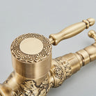 Detail of the carved antique brass faucet valve cap with Greek-key border and lever