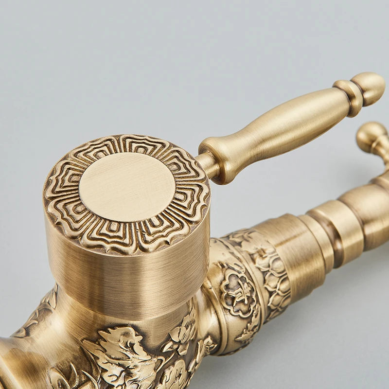 Detail of the carved antique brass faucet valve cap with Greek-key border and lever