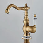 Carved antique brass swivel faucet with single handle