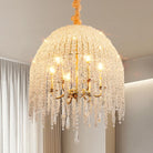 Close-up of six candle lights inside a dome of crystal-look bead strands on a gold frame