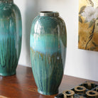 Close view of the teal-to-blue drip glaze on the ceramic vase