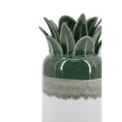 Close-up of the glossy green leaf top and white ombre base of the ceramic pineapple vase