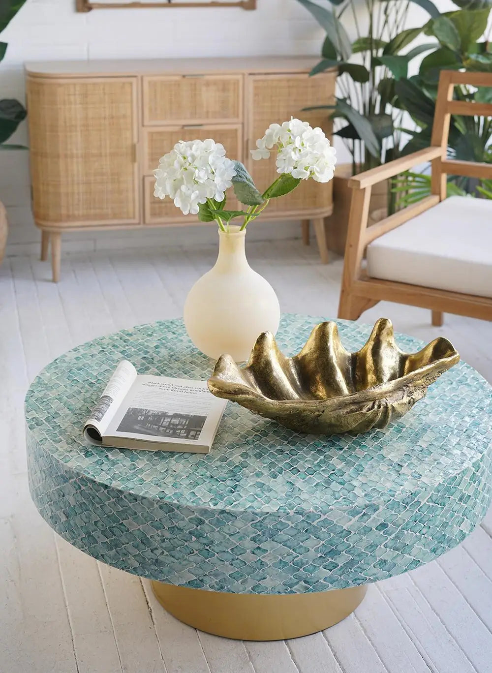 Frosted glass bubble vase with white flowers on a mosaic table