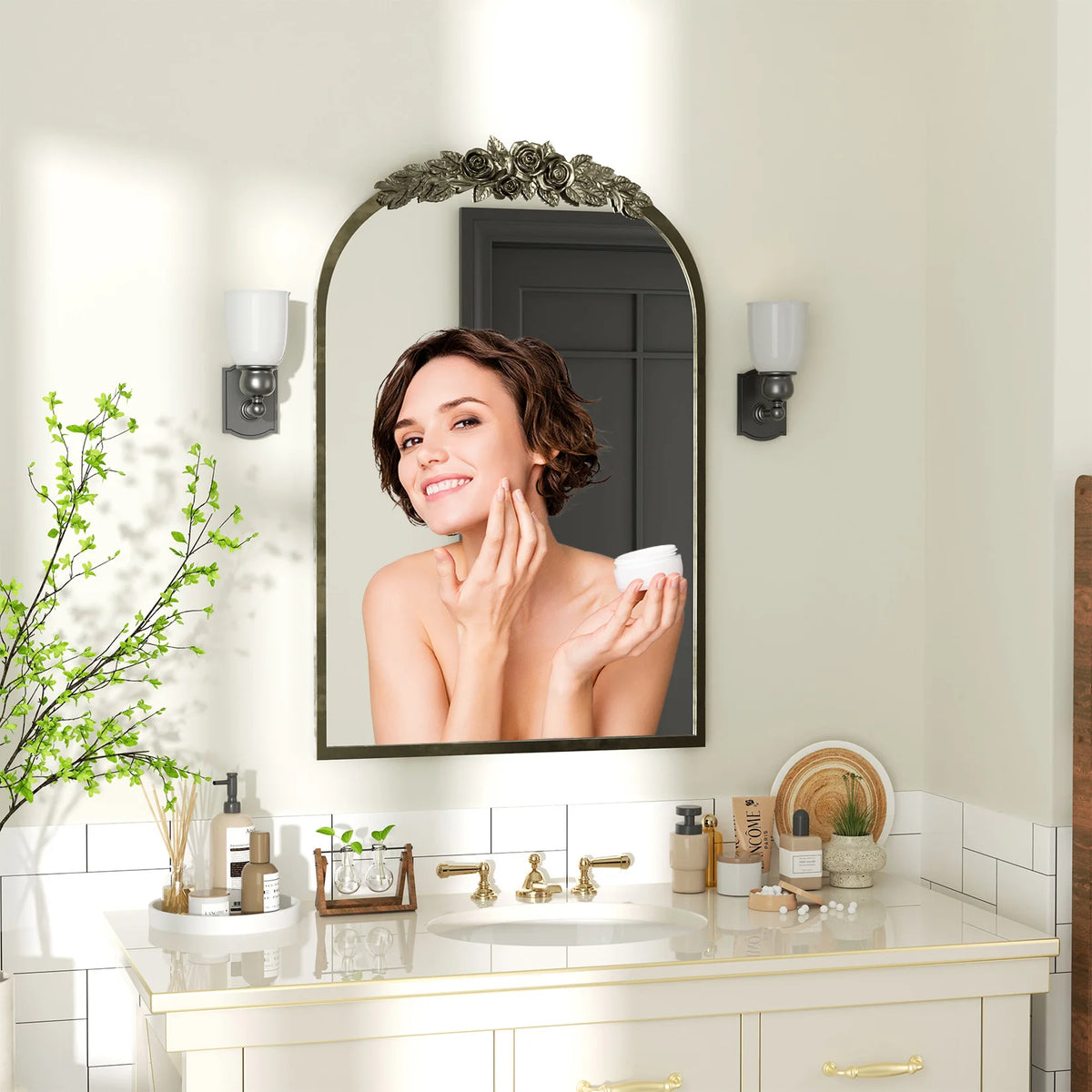 Antique brass baroque arched mantel mirror above a white bathroom vanity