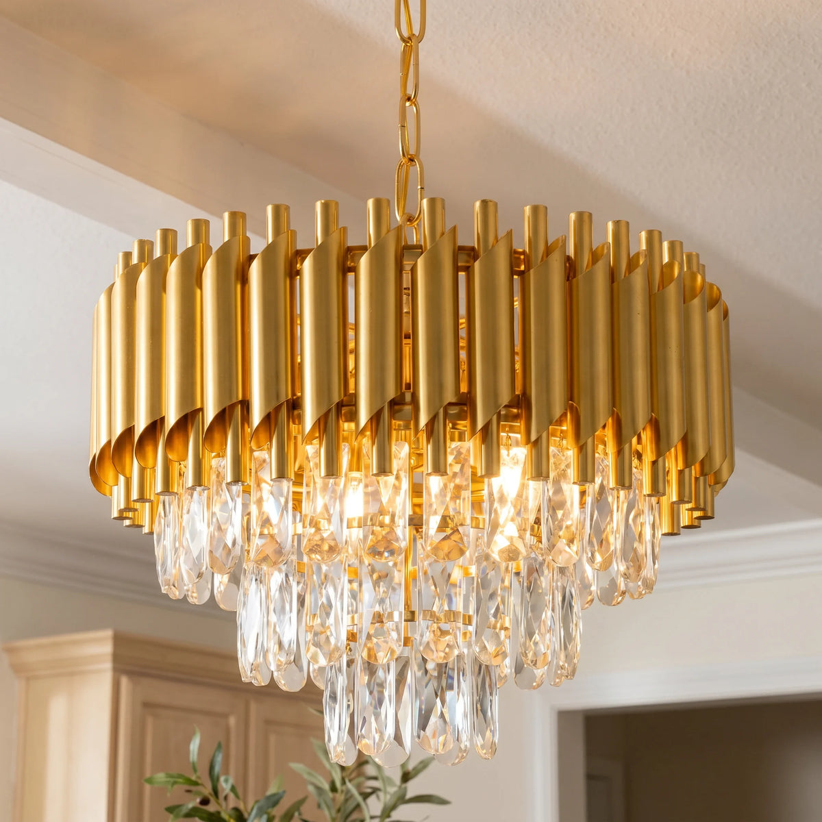 Close-up of the gold fluted crown chandelier with three tiers of clear K9 crystals