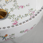 Close-up of the flower-and-bird pattern and dotted rim