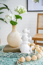 Frosted glass vase with white hydrangeas on a coffee table