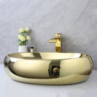 Gold oval vessel sink and waterfall faucet, side view