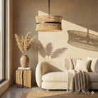 Natural rattan four-light drum pendant with a dark center band in a living room