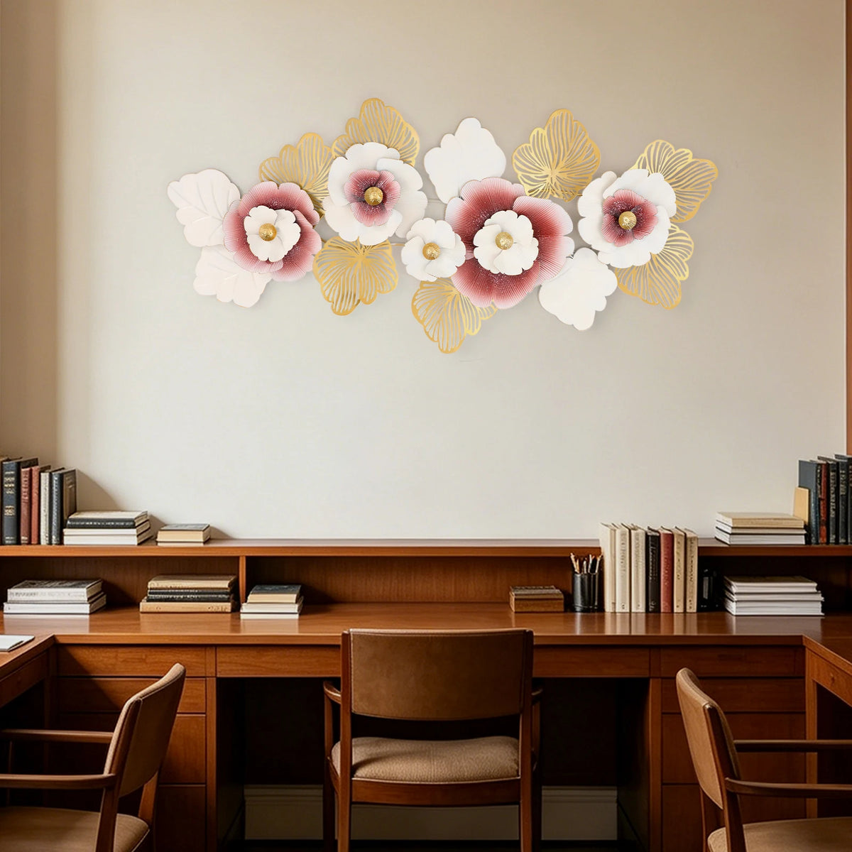 Large pink and gold metal flower wall sculpture hung above a wood desk and bookshelf