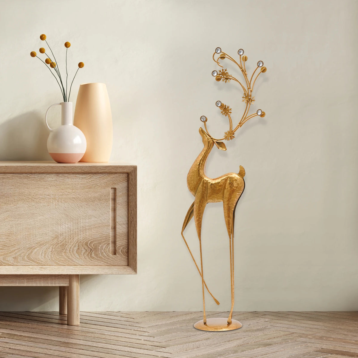 Gold metal deer sculpture with faux-crystal antlers (in a living room)