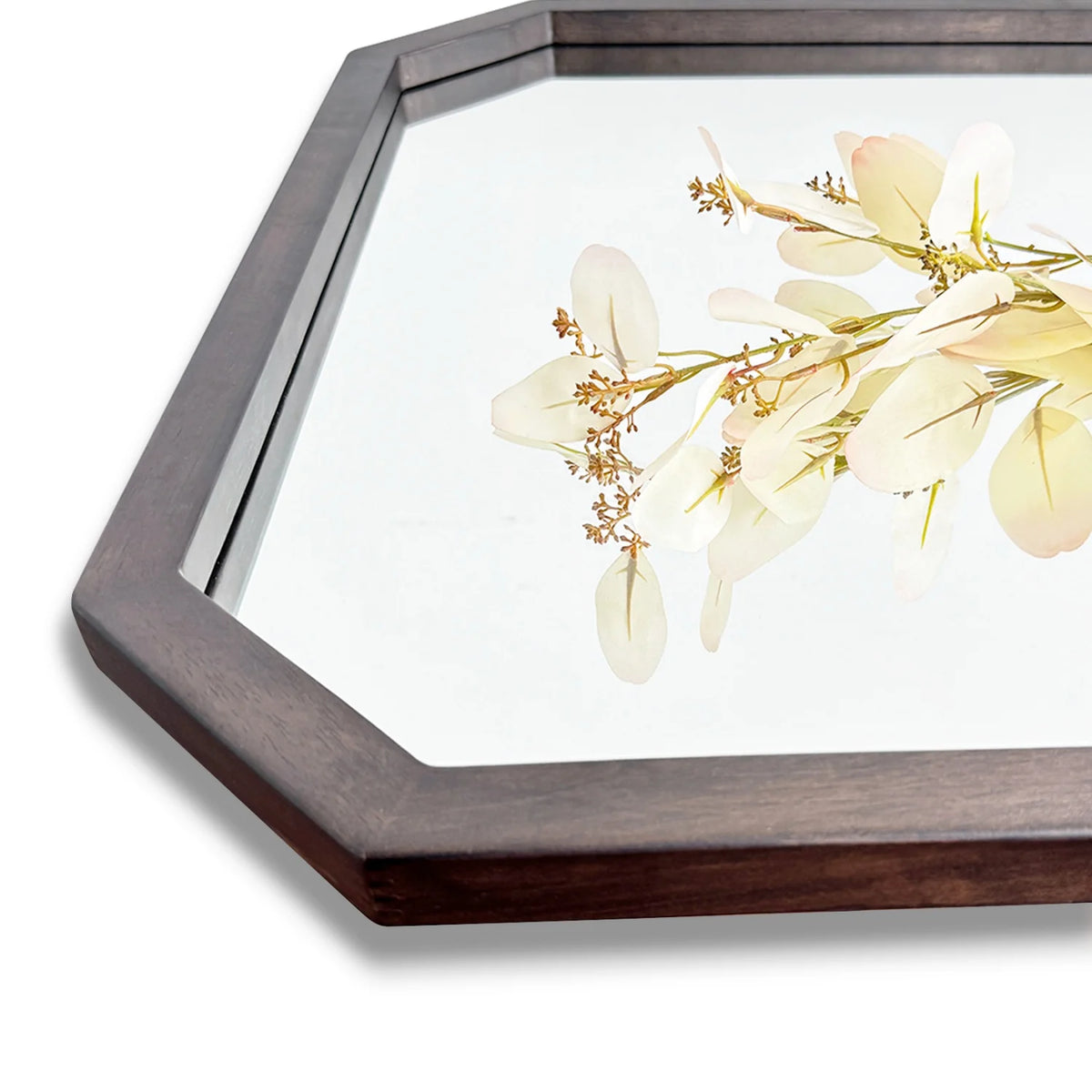 Close-up of the octagon walnut wood mirror frame corner showing its beveled edge