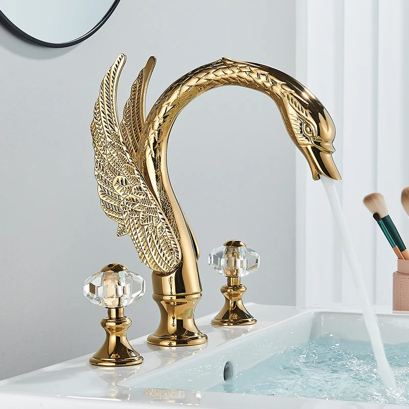 Gold Swan Widespread Faucet with Crystal Handles, on a white basin