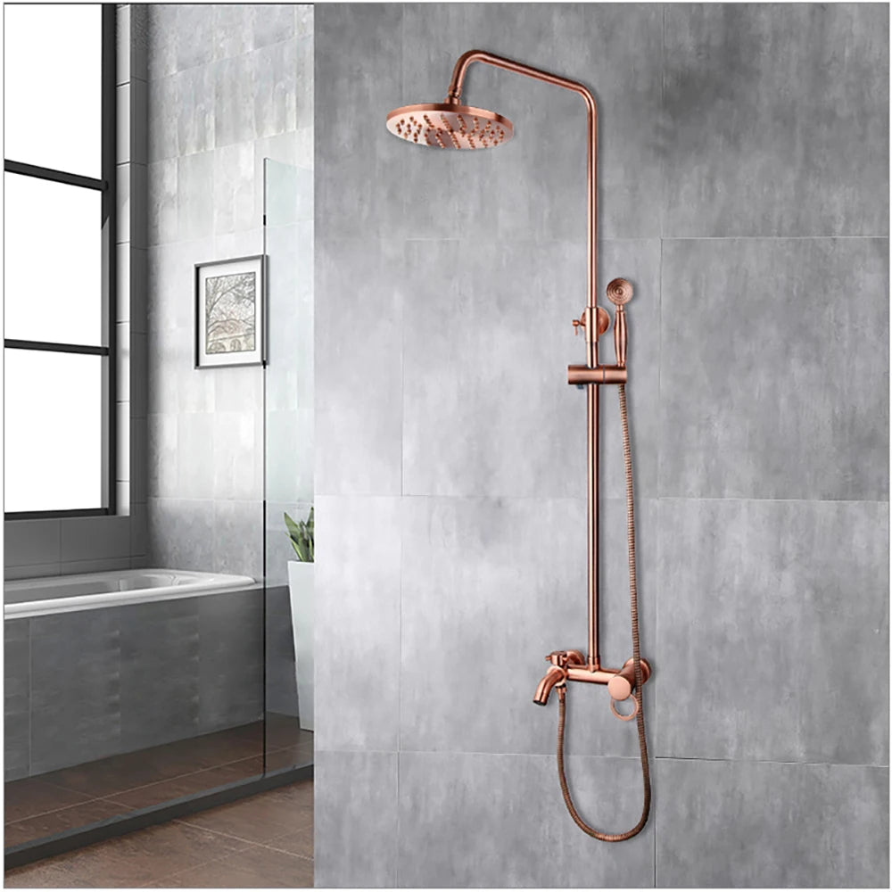 Antique copper rainfall shower with round head, slide bar and hand shower on a gray wall