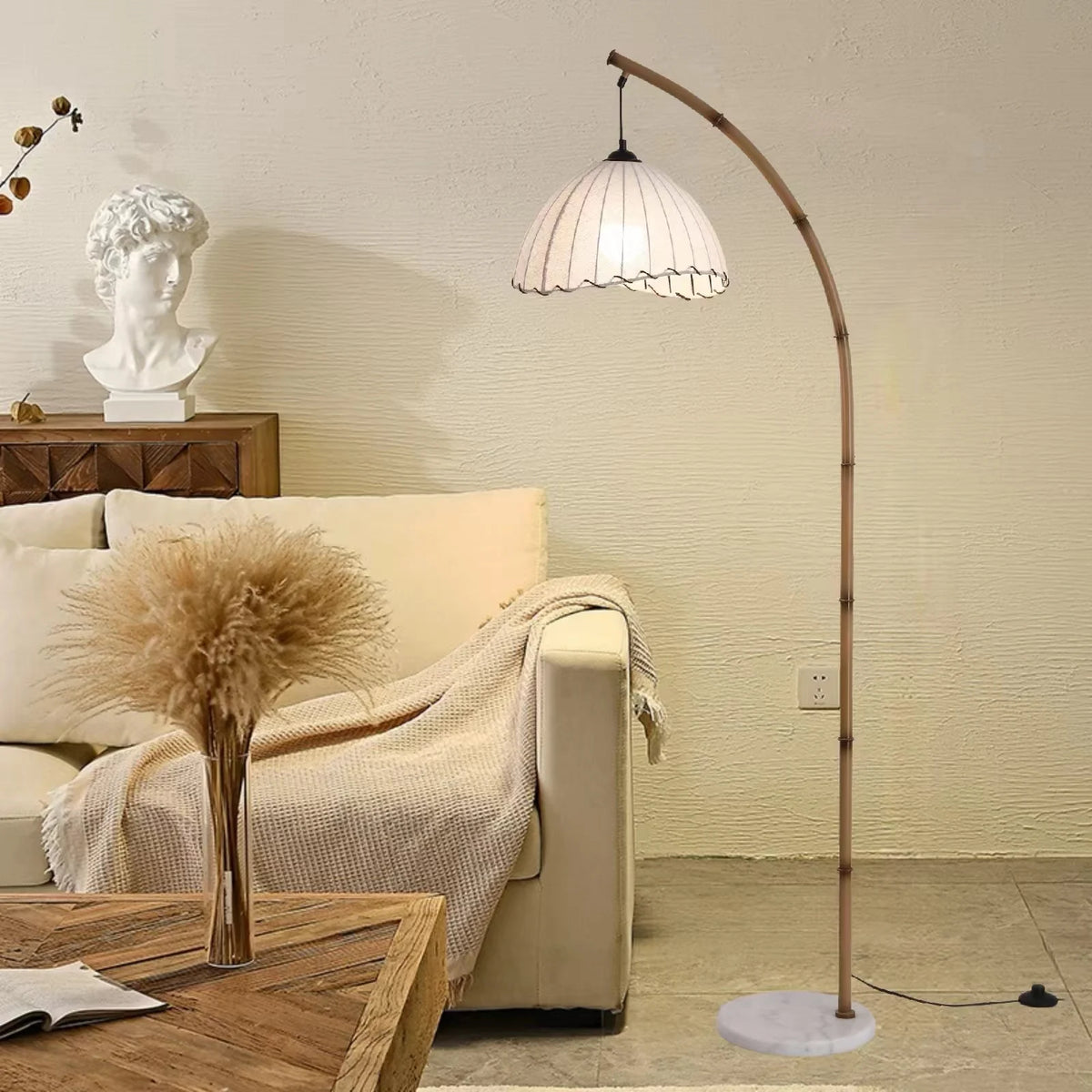 Bamboo arc floor lamp with marble base in a living room