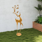 Gold metal deer sculpture with faux-crystal antlers (on a lawn)