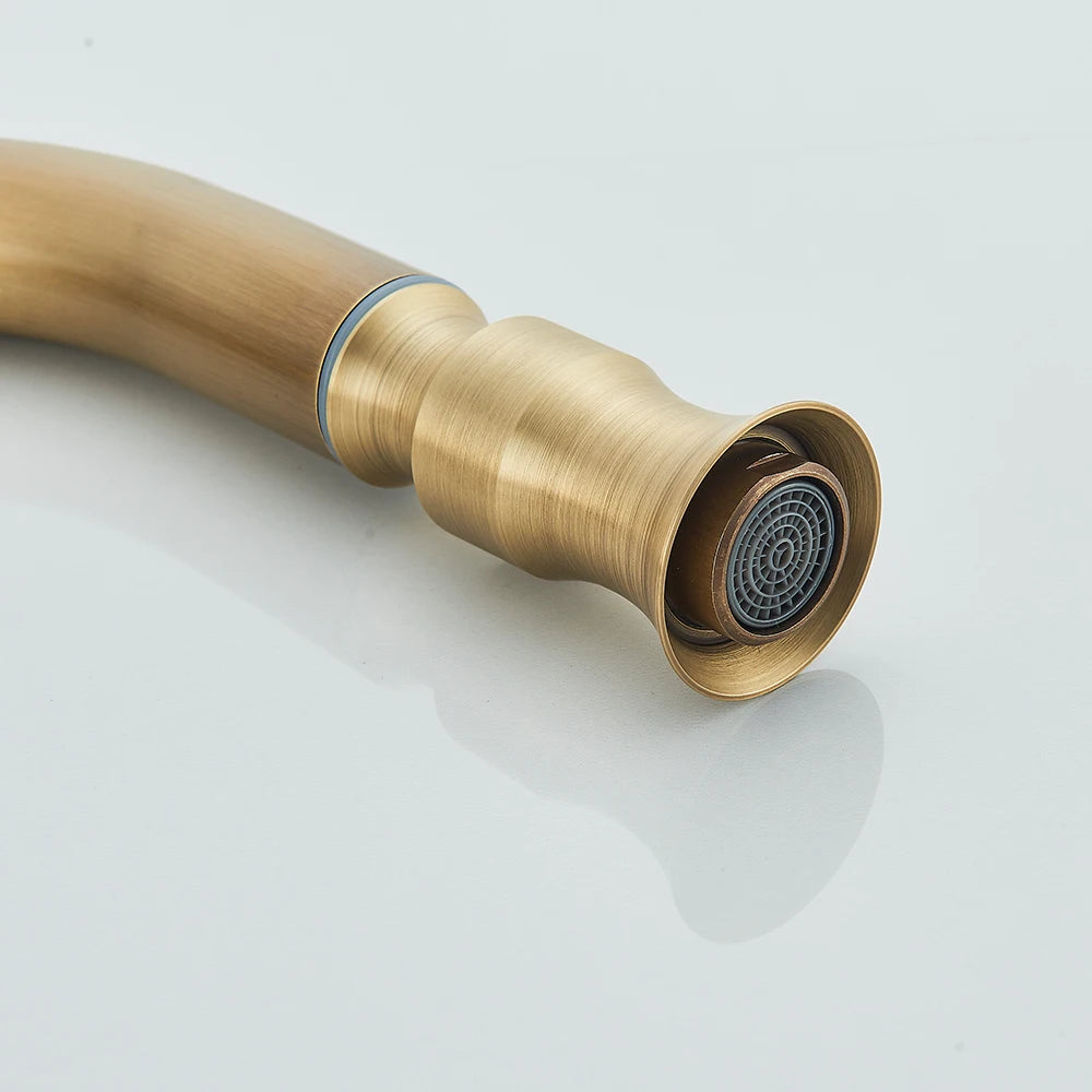 Detail of the antique brass kitchen faucet spray head with ringed collar and aerator