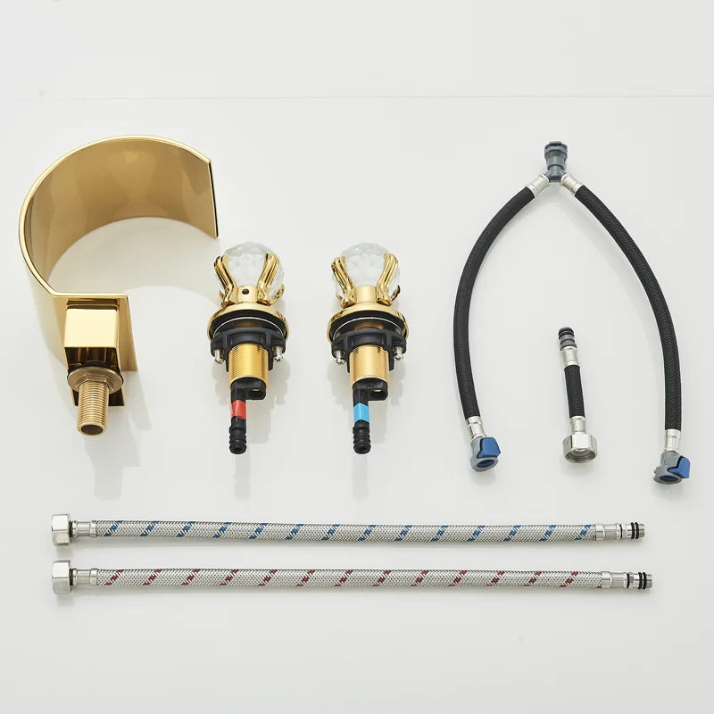 Gold widespread bathroom faucet components with spout, two crystal-style valves and supply hoses