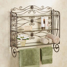 Antique bronze scrollwork bath shelf mounted on a cream wall