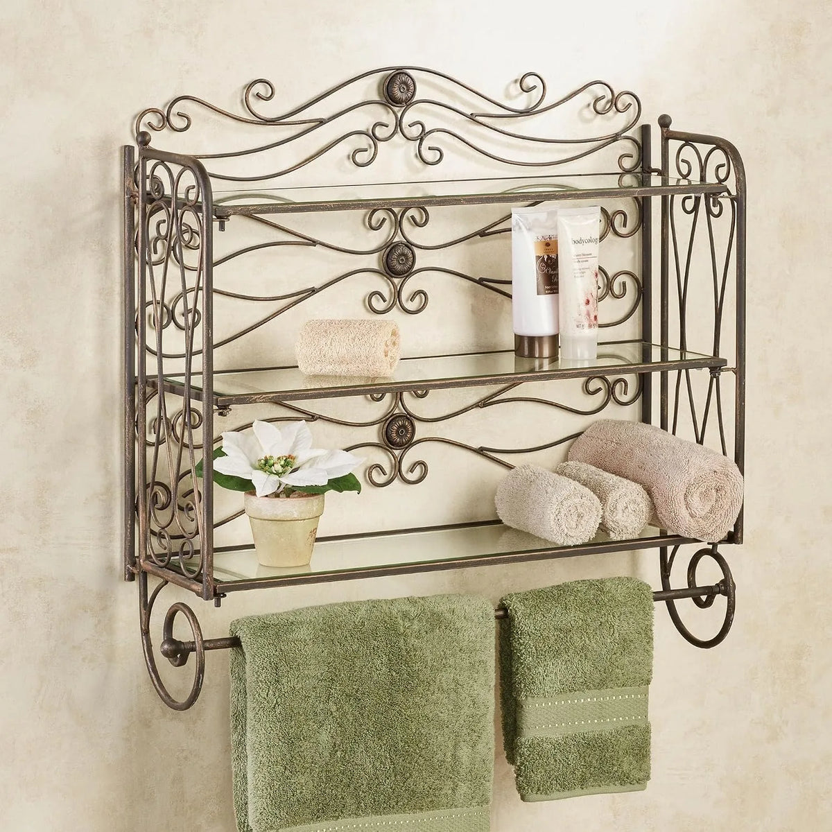 Antique bronze scrollwork bath shelf mounted on a cream wall