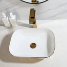 Gold hammered ceramic vessel sink with white basin and gold waterfall faucet