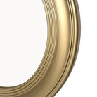 Close-up of the molded brushed gold mirror frame