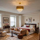 Three-tier gold fluted crystal chandelier lighting a traditional bedroom sitting area