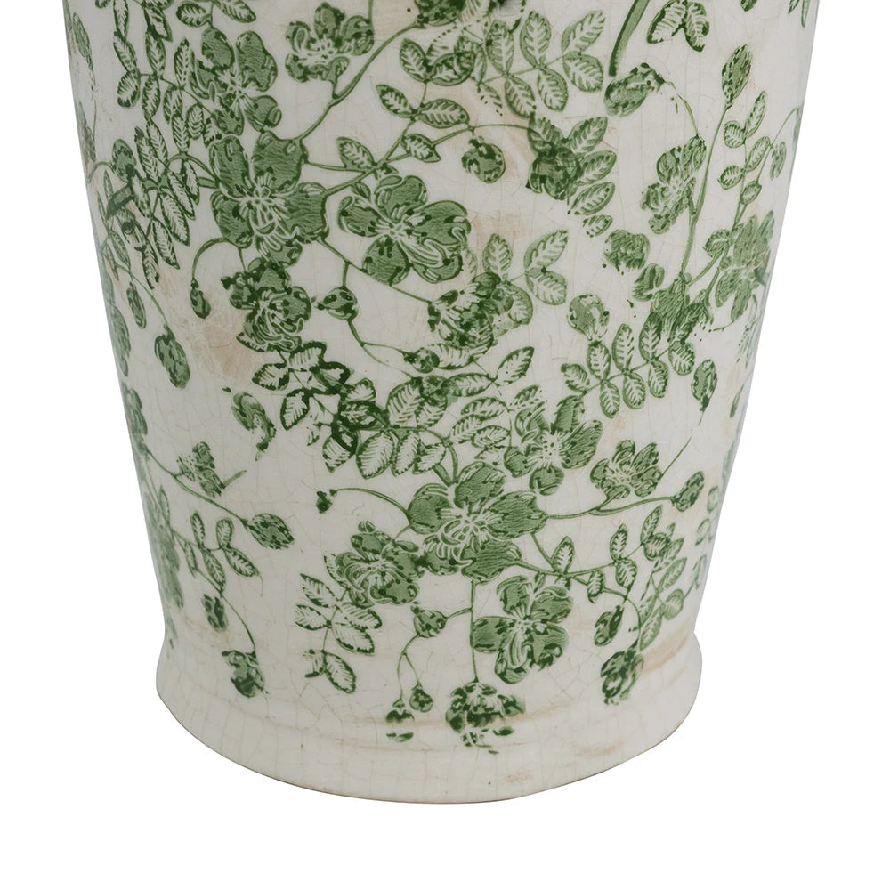 Close-up of the green floral pattern on white ceramic