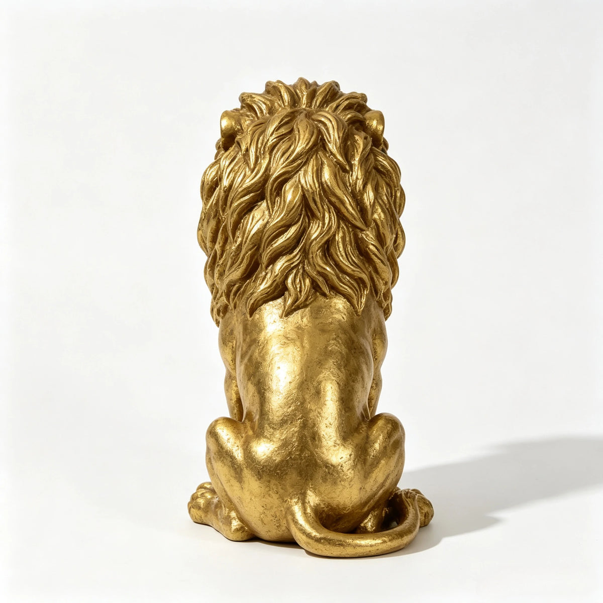 Gold seated lion statue, back view of the carved mane