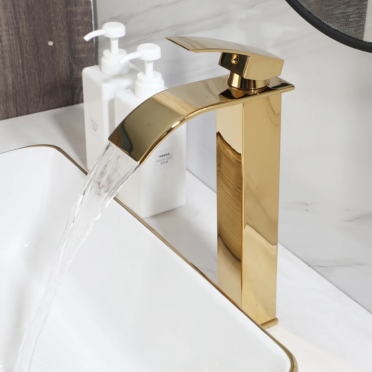 White square ceramic vessel sink with gold stripes, close-up of the gold faucet