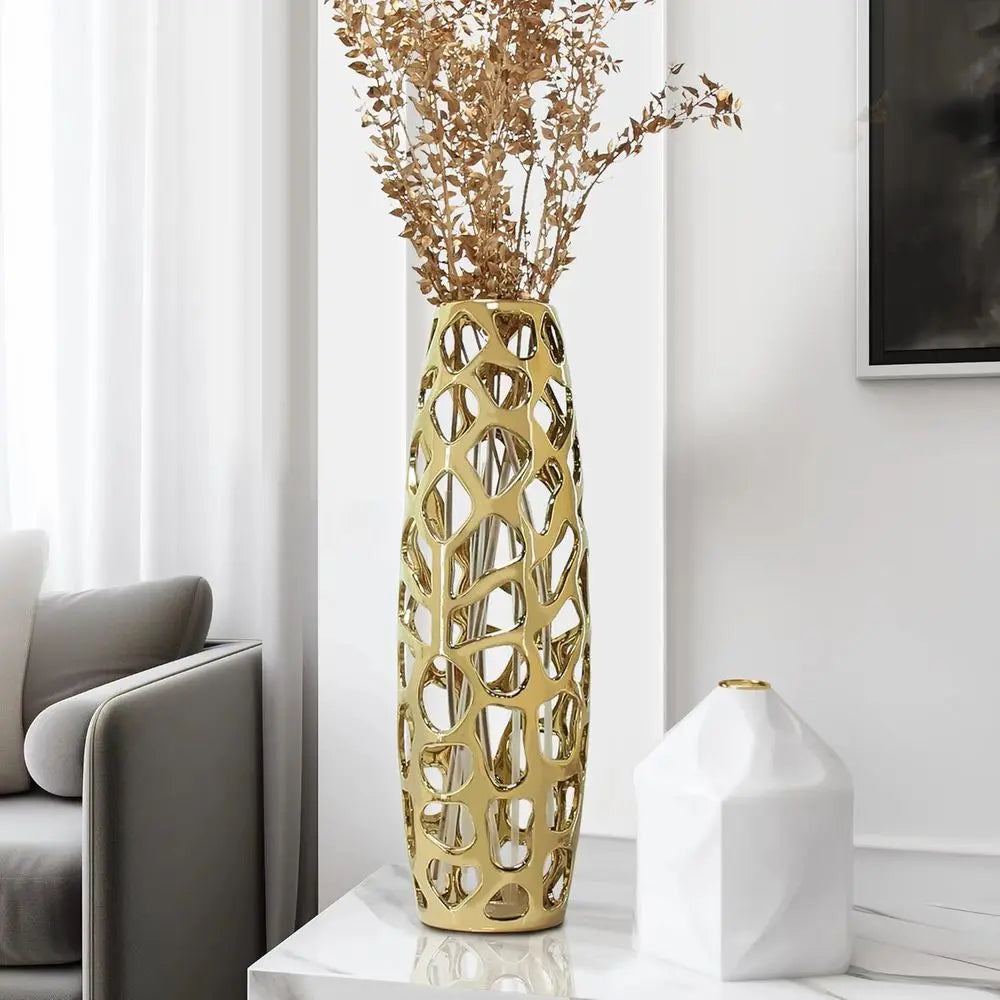 Gold lattice ceramic vase holding dried branches