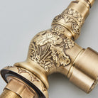 Detail of floral relief carving on the antique brass faucet body and threaded base